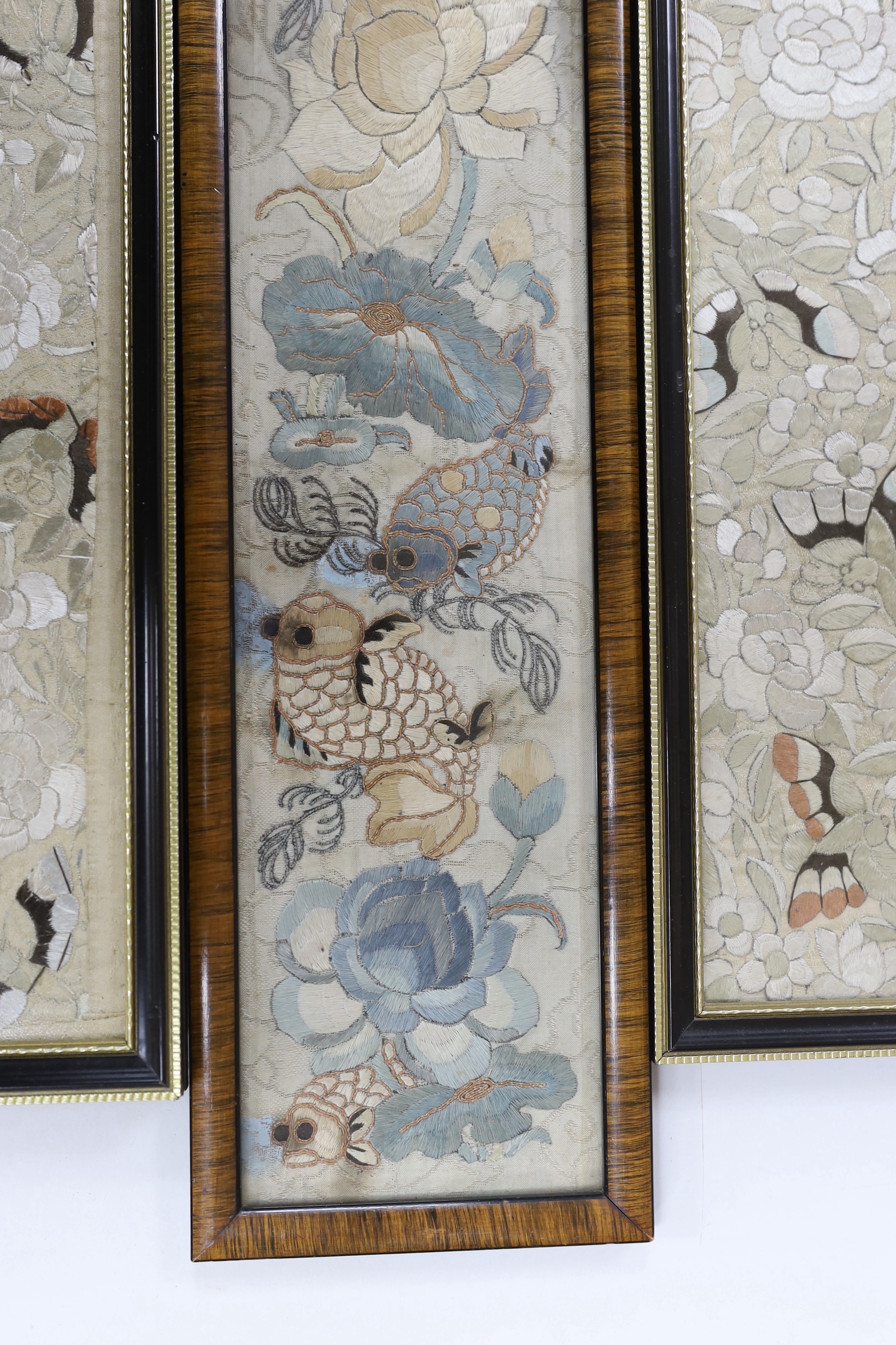 Three 19th century Chinese framed silk panels with embroidered decoration, largest 12 x 55cm